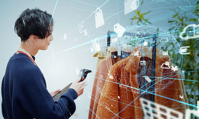 Store clerk scanning products with a smart phone. Retail as a Service. RaaS. stock photo